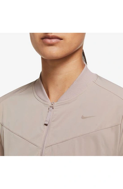 Shop Nike Dri-fit Bliss Bomber Jacket In Diffused Taupe/ Clear