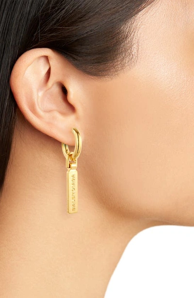 Shop Balenciaga Logo Tag Drop Huggie Hoop Earrings In Gold