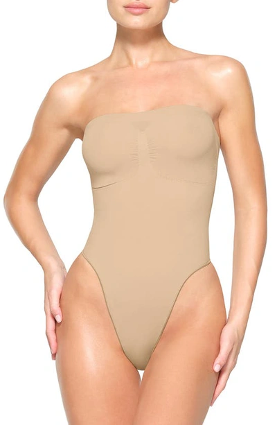 Skims Beige Seamless Sculpt Deep Plunge Thong Bodysuit In Clay