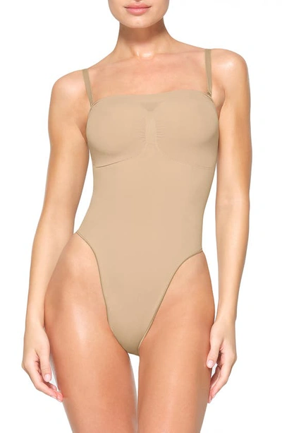 Skims Beige Seamless Sculpt Deep Plunge Thong Bodysuit In Clay