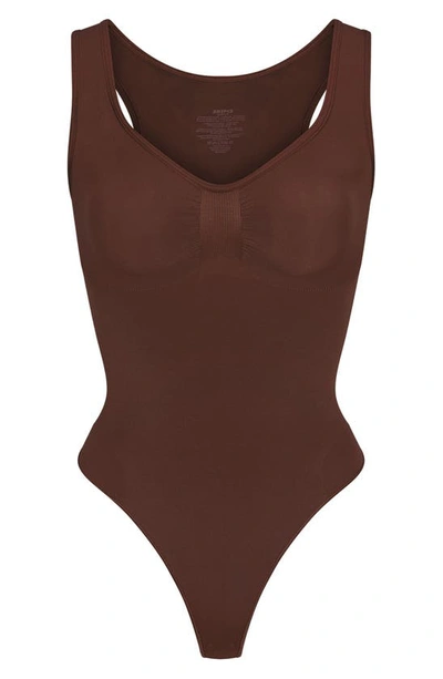 Shop Skims Seamless Sculpt Scoop Neck Thong Bodysuit In Cocoa