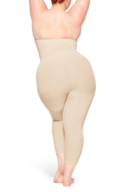 Shop Skims Seamless Sculpt Catsuit In Sand