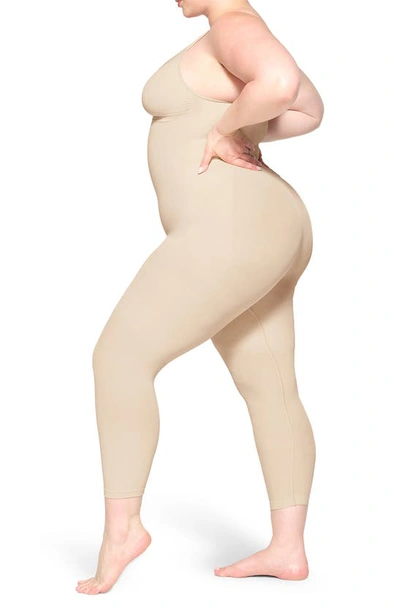 Shop Skims Seamless Sculpt Catsuit In Sand