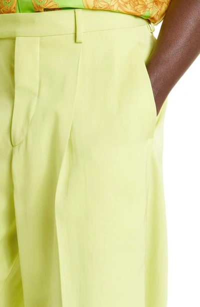 Shop Versace Fluid Satin Twill Pleat Front Pants In Lime