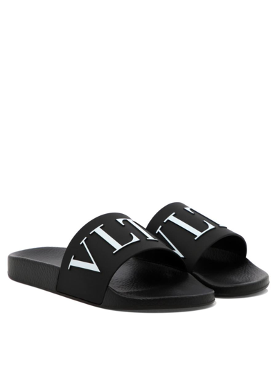 Shop Valentino "vltn" Sandals In Black