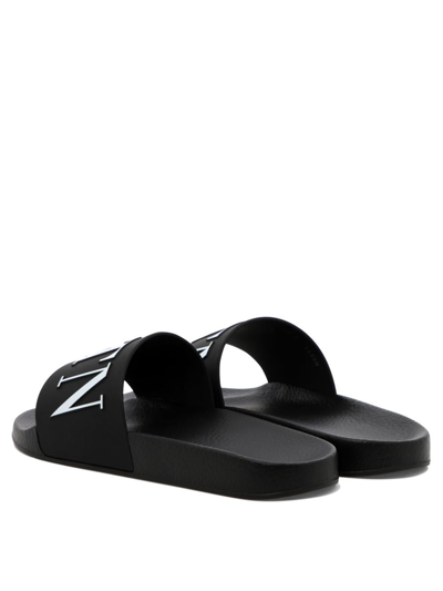 Shop Valentino "vltn" Sandals In Black