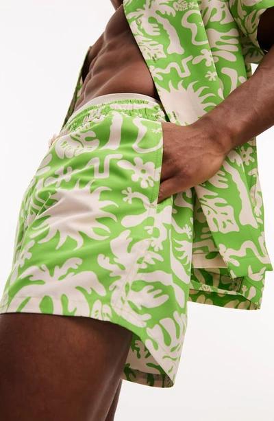 Shop Asos Design Tropical Print Short Swim Trunks In Green Multi