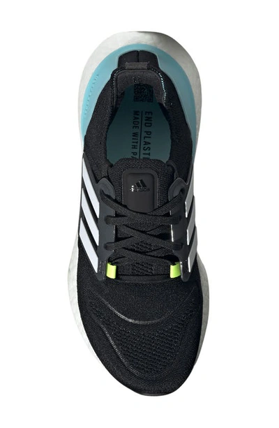 Shop Adidas Originals Ultraboost 22 Running Shoe In Black/ White/ Solar Yellow