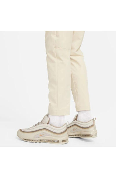 Shop Nike Woven Tapered Leg Pants In Sanddrift/ White
