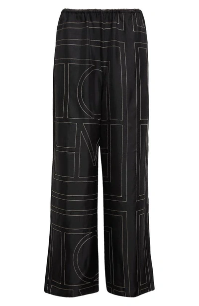 Shop Totême Monogram Silk Pajama Bottoms In Black Monogram