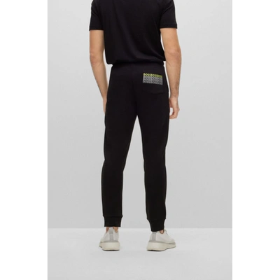 Shop Hugo Boss Regular-fit Tracksuit Bottoms With Multi-colored Logos In Black