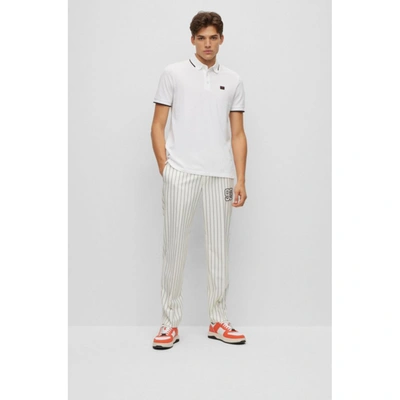 Shop Hugo Cotton-piqu Slim-fit Polo Shirt With Logo Label In White