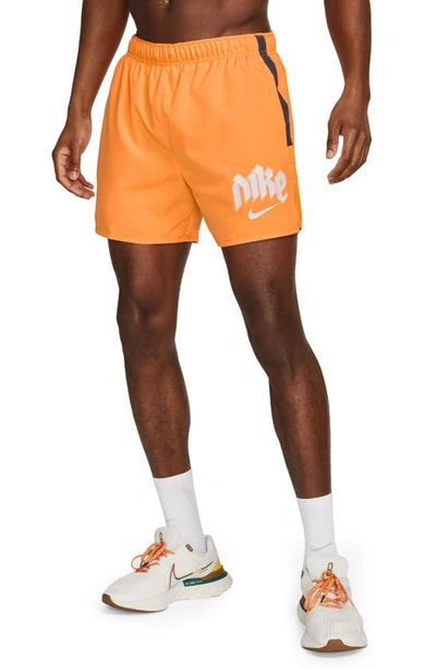 Shop Nike Dri-fit Challenger 5-inch Brief Lined Shorts In Orange/ Reflective Silver