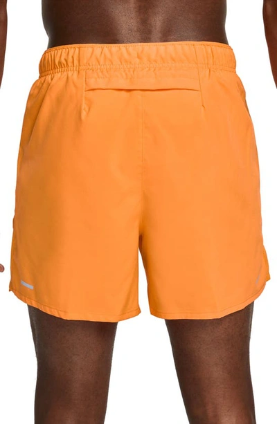 Shop Nike Dri-fit Challenger 5-inch Brief Lined Shorts In Orange/ Reflective Silver