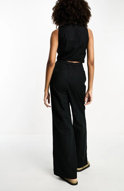 Shop Asos Design Button-up Wide Leg Cotton Blend Jumpsuit In Black