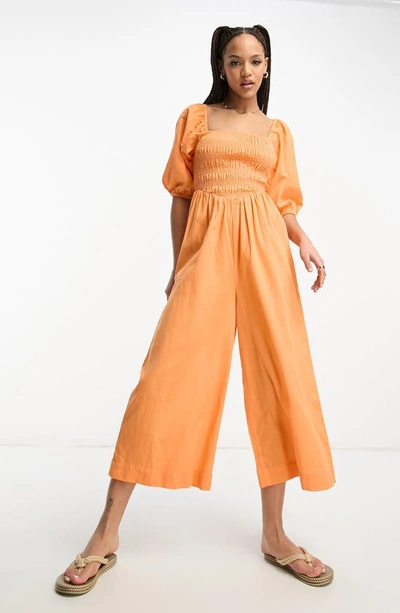 Shop Asos Design Smocked Puff Sleeve Wide Leg Crop Jumpsuit In Orange