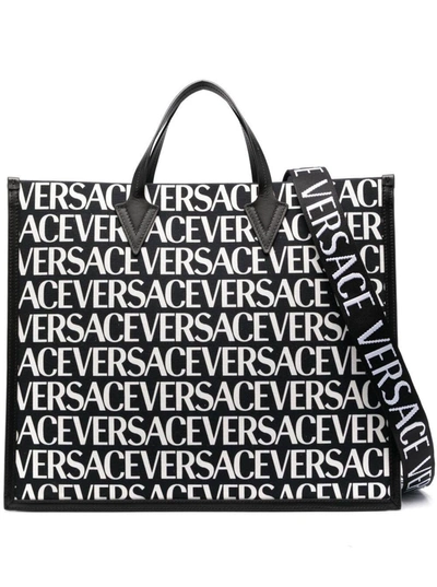 Shop Versace Repeat Tote Bag With All-over Logo Print In Black Canvas Woman