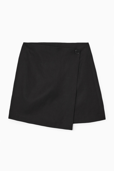 Shop Cos Asymmetric Mini Wrap Skirt In Black