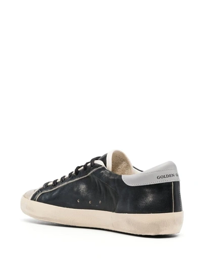 Shop Golden Goose 'super-star' Black Low Top Sneakers With Logo Patch And Suede Details In Leather Man