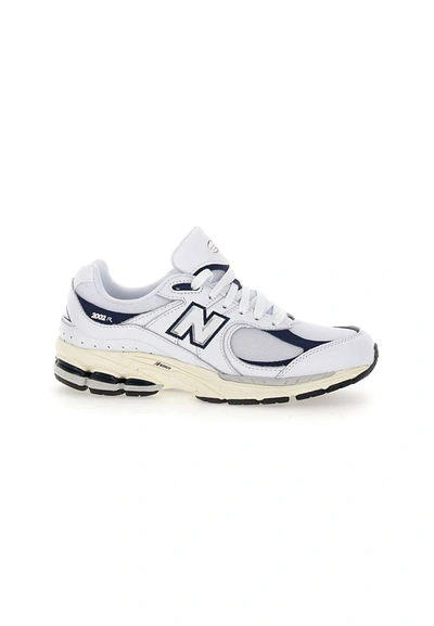 Shop New Balance "2002r" Sneakers In White