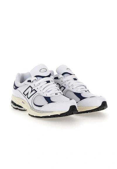 Shop New Balance "2002r" Sneakers In White