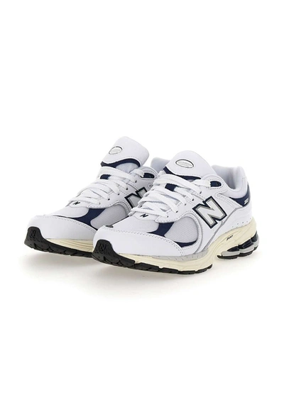 Shop New Balance "2002r" Sneakers In White