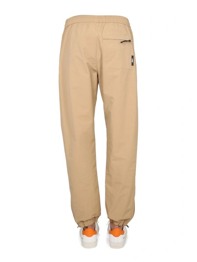 Shop Msgm Pants With Logo In Beige
