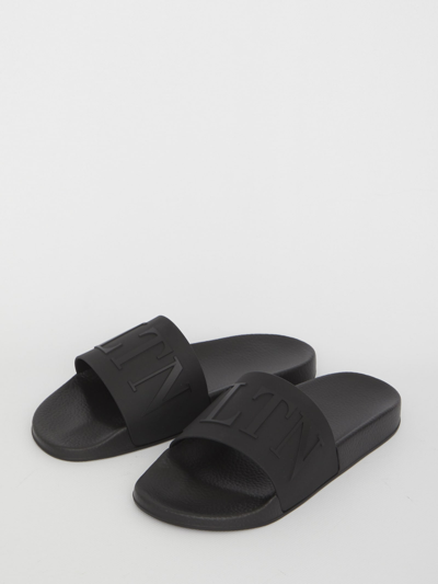 Shop Valentino Vltn Slippers In Black