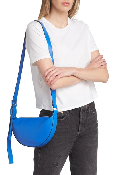 Shop Allsaints Half Moon Leather Crossbody Bag In Cala Blue