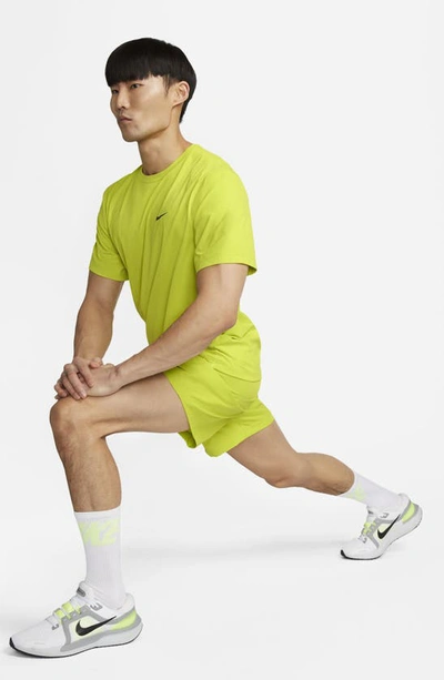 Shop Nike Form Dri-fit Athletic Shorts In Bright Cactus/ Black