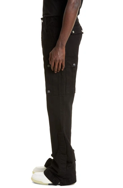 Shop Amiri M65 Distressed Split Hem Kick Flare Leg Cargo Jeans In Black