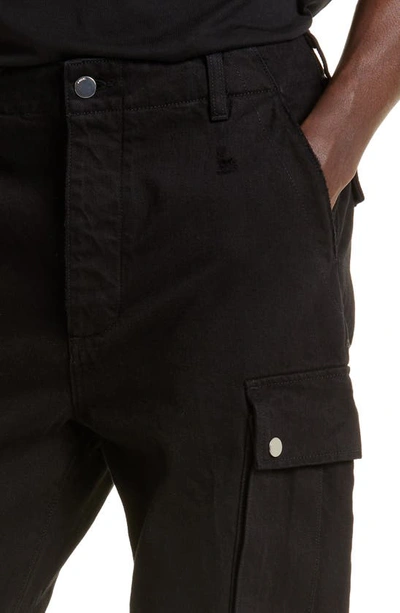 Shop Amiri M65 Distressed Split Hem Kick Flare Leg Cargo Jeans In Black