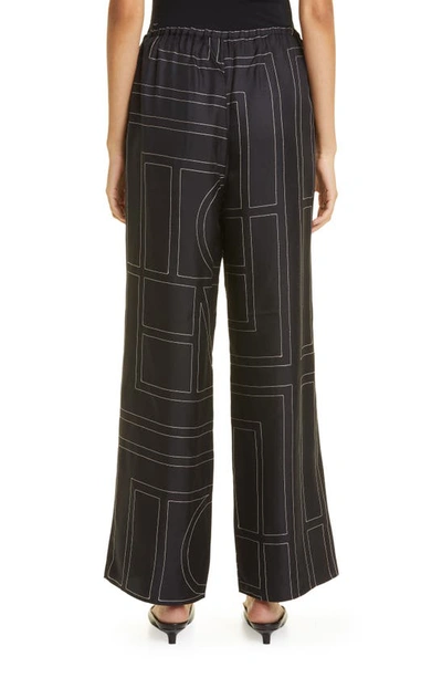 Shop Totême Monogram Silk Pajama Bottoms In Black Monogram