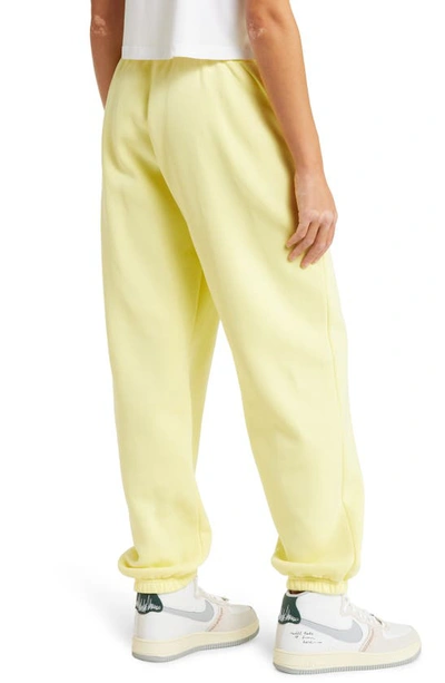 Shop Nike Sportswear Phoenix High Waist Fleece Sweatpants In Lemon Chiffon/ Black