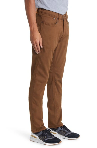 Shop Duer No Sweat Relaxed Tapered Performance Pants In Golden
