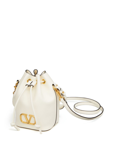 Shop Valentino Mini Vlogo Signature Leather Bucket Bag In White