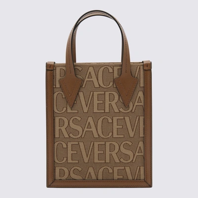 Shop Versace Brown Canvas And Leather Allover Handle Bag In Beige