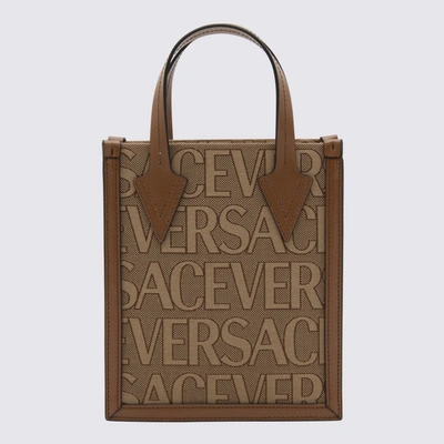 Shop Versace Brown Canvas And Leather Allover Handle Bag In Beige