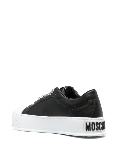 Shop Moschino Embossed-logo Low-top Sneakers In Black