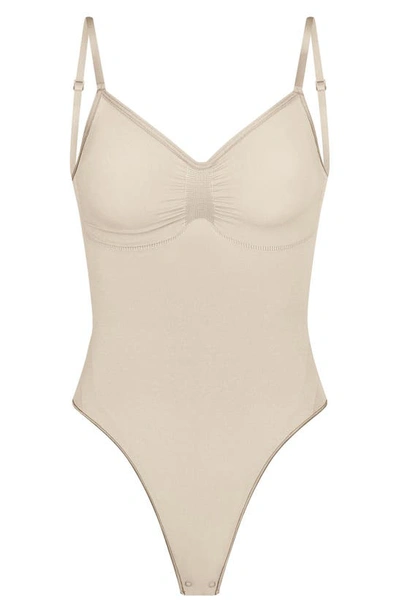 Skims Seamless Sculpt Low Back Thong Bodysuit In Sand