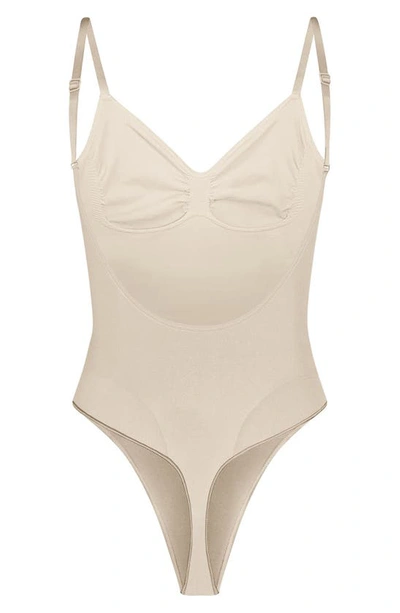 Skims Seamless Sculpt Low Back Thong Bodysuit In Sand
