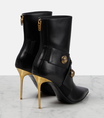 Balmain Black Ankle Boots Embellished With Gold Embossed Buttons In Black