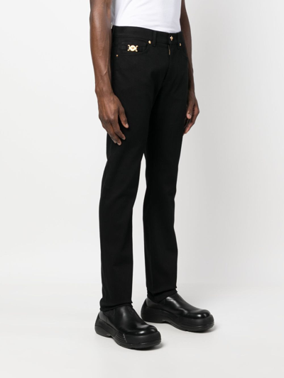 Shop Versace Mid-rise Slim-fit Jeans In Black