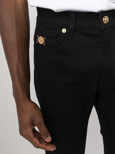 Shop Versace Mid-rise Slim-fit Jeans In Black