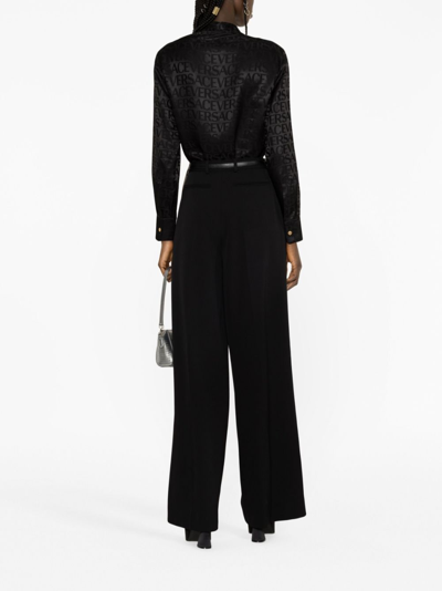 Shop Versace Pleated Wide-leg Stretch-wool Trousers In Black