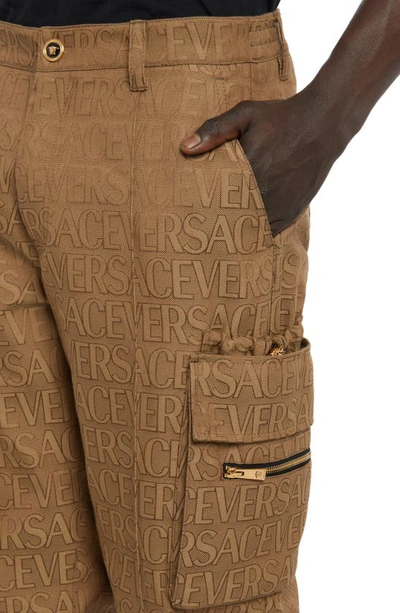 Shop Versace Allover Logo Jacquard Techno Canvas Cargo Joggers In Brown Beige