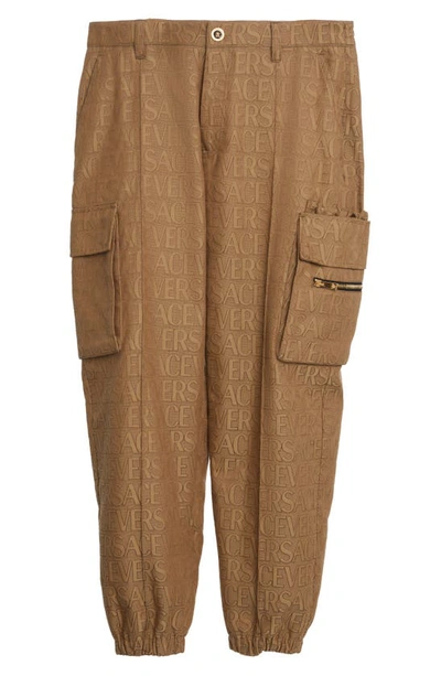 Shop Versace Allover Logo Jacquard Techno Canvas Cargo Joggers In Brown Beige