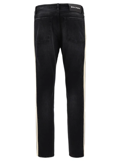 Shop Palm Angels Side Band Jeans In Black