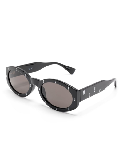 Shop Moschino Eyewear Logo-lettering Oval-frame Sunglasses In Black