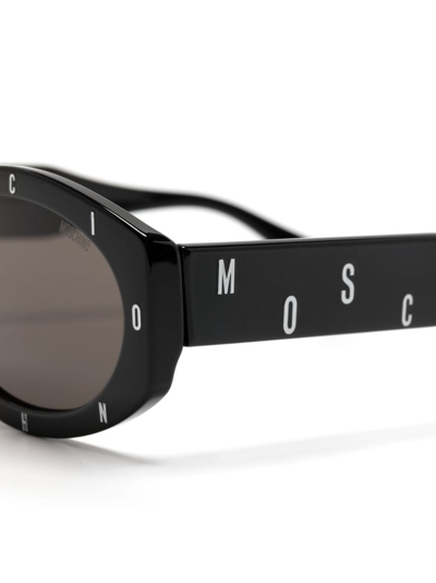 Shop Moschino Eyewear Logo-lettering Oval-frame Sunglasses In Black
